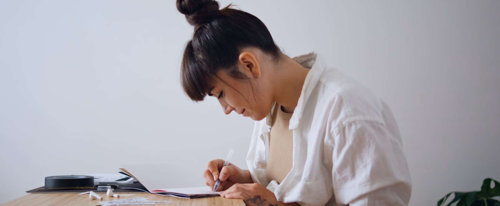 Student learning Chinese calligraphy in classroom